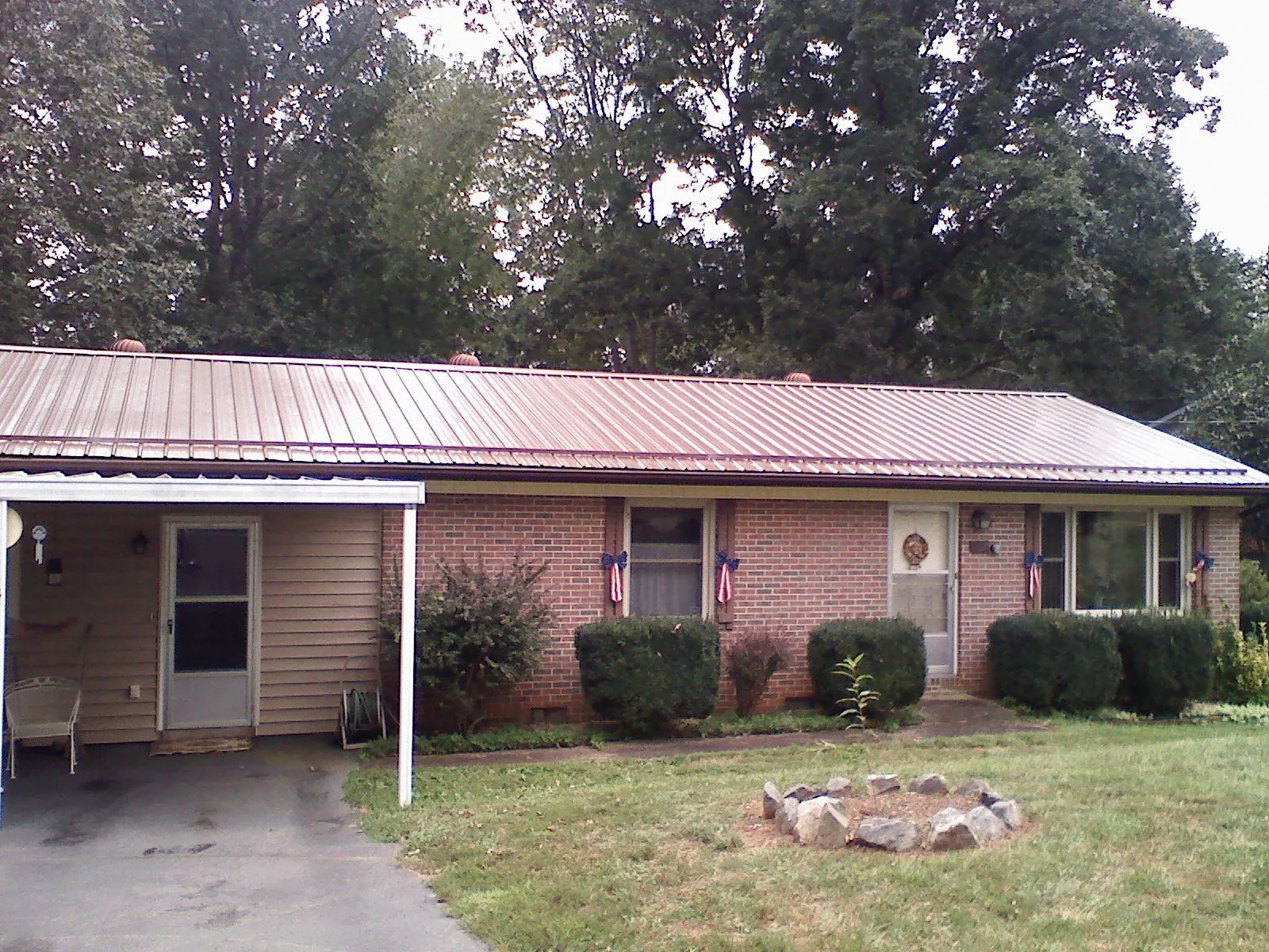 Bronze metal roof and carport on a brick ranch home — Roof Repair work by our crew in West Hartland
